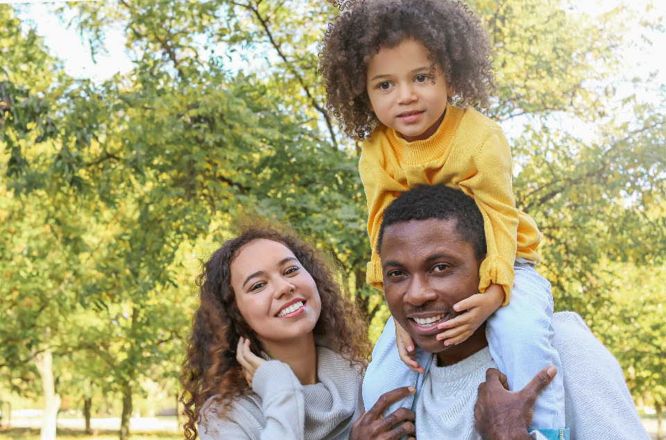 A family laughing together outdoors